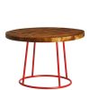 Round coffee table with dark wooden top and red legs