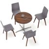 Overhead view of four grey chairs around a circular wooden table