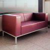 Maroon two seater sofa in a leather finish