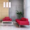 Red armchair and red sofa with a frosted glass coffee table