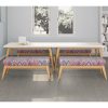 Patterned bench seating around a white wooden table